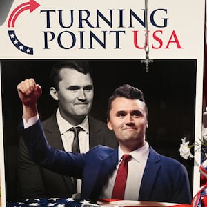 A pile of flowers, candles, and photos placed outside the original Turning Point USA office in Lemont, founded by Charlie Kirk, on Sunday, September 21, 2025.