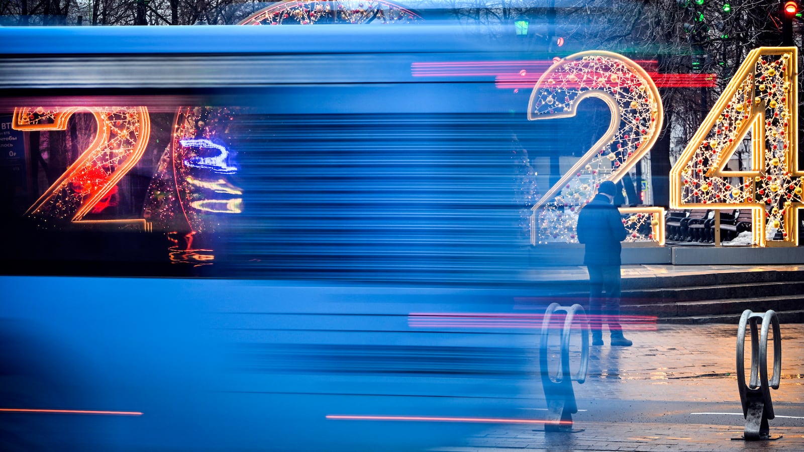 A bus drives past a New Year 2024 numerals decoration in central Moscow on Dec. 31, 2023.