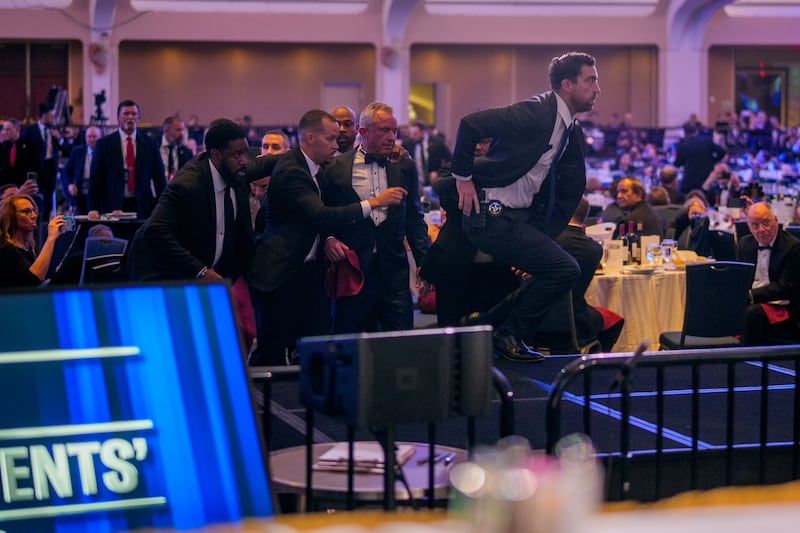 Health and Human Services Secretary Robert F. Kennedy Jr. (C) is taken out of the ballroom by security agents during a shooting incident at the annual White House Correspondents Association Dinner at the Washington Hilton on April 25, 2026 in Washington, DC.