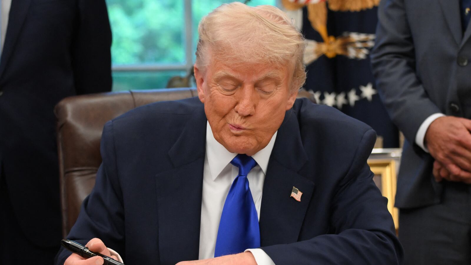 TOPSHOT - US President Donald Trump signs executive orders in the Oval Office of the White House, in Washington, DC, on May 5, 2025. Trump signed several health care-related executive orders, according to a White House statement. (Photo by Alex Wroblewski / AFP) (Photo by ALEX WROBLEWSKI/AFP via Getty Images)