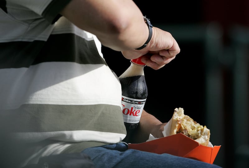 SAN FRANCISCO - JULY 24:  A man opens a bottle of Diet Coke as he eats before the start of the baseball game with the San Francisco Giants and the Atlanta Braves at AT&T Park July 24, 2007 in San Francisco, California. A study published in the Journal of the American Heart Association states that drinking diet soda can increase the risk of "metabolic syndrome," a contributor to heart disease and diabetes, by 48 percent.  (Photo by Justin Sullivan/Getty Images)