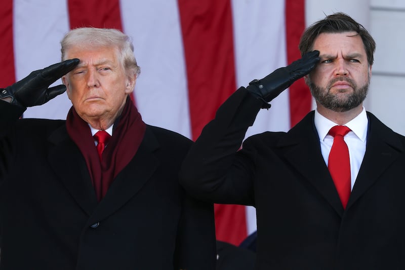 U.S. President Donald Trump and U.S. Vice President JD Vance salute during a ceremony at Memorial Amphitheater at Arlington National Cemetery to mark Veterans Day.