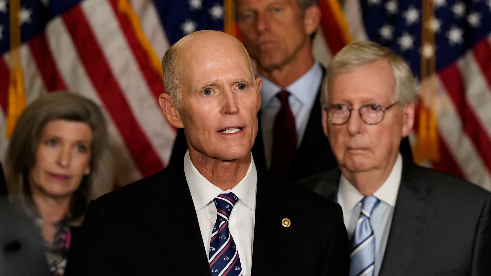 Senator Rick Scott (R-FL) speaks to reporters as Senators Joni Ernst (R-IA), John Thune (R-SD) and Senate Minority Leader Mitch McConnell (R-KY) listen at the U.S. Capitol in Washington.