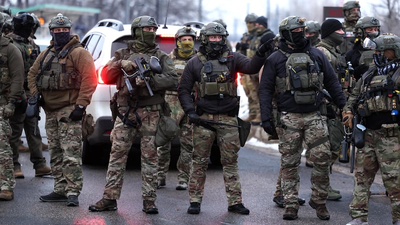 US Border Patrol agents holding less-lethal weapons stand guard at the Bishop Henry Whipple Federal Building in Minneapolis, Minnesota, on January 8, 2026. A US Immigration and Customs Enforcement (ICE) agent shot and killed an American woman on the streets of Minneapolis January 7, leading to huge protests and outrage from local leaders who rejected White House claims she was a domestic terrorist. The woman, identified in local media as 37-year-old Renee Nicole Good, was hit at point blank range as she apparently tried to drive away from agents who were crowding around her car, which they said was blocking their way.
