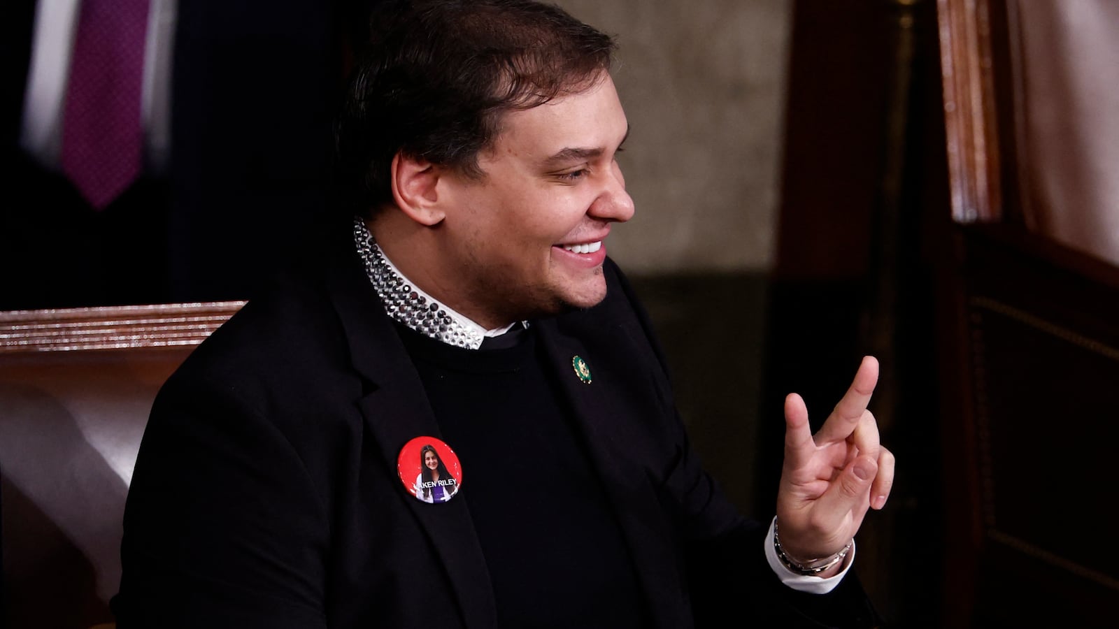 George Santos gives a peace sign during the State of the Union.