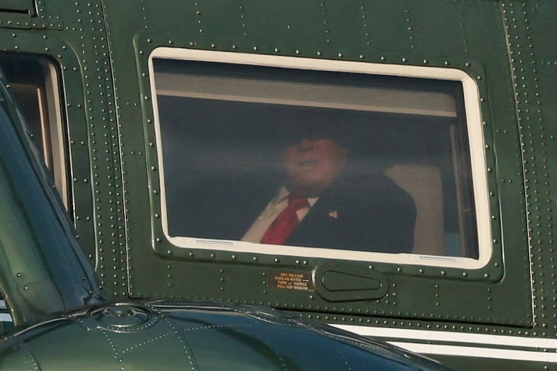 U.S. President Donald Trump looks through a window as he flies on board Marine One, after travelling to Dover, Delaware and Marietta, Georgia, in Washington, D.C., U.S., July 22, 2026. REUTERS/Kylie Cooper