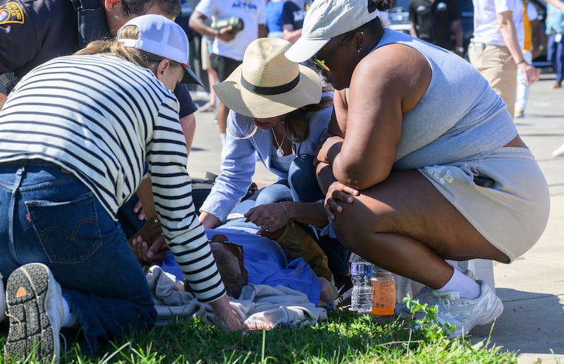 Dr. Amy Acton, the Democratic candidate for Governor of Ohio, helps an elderly woman who collapsed along the parade route of the 54th Annual CDC Parade on September 7, 2026 in Cleveland, Ohio.