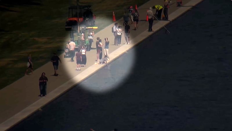 The US Park Police are looking for a woman seen reaching into the reflecting pool.