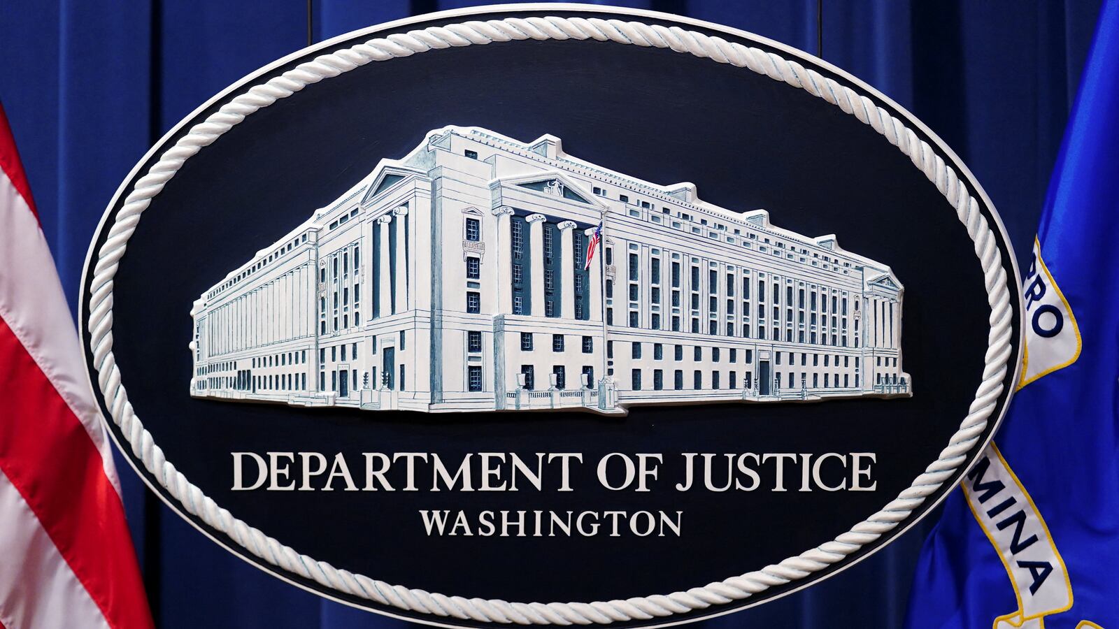 A U.S. Justice Department logo or seal showing Justice Department headquarters
