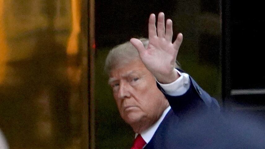 Donald Trump waves to cameras while arriving at Trump Tower in New York City.