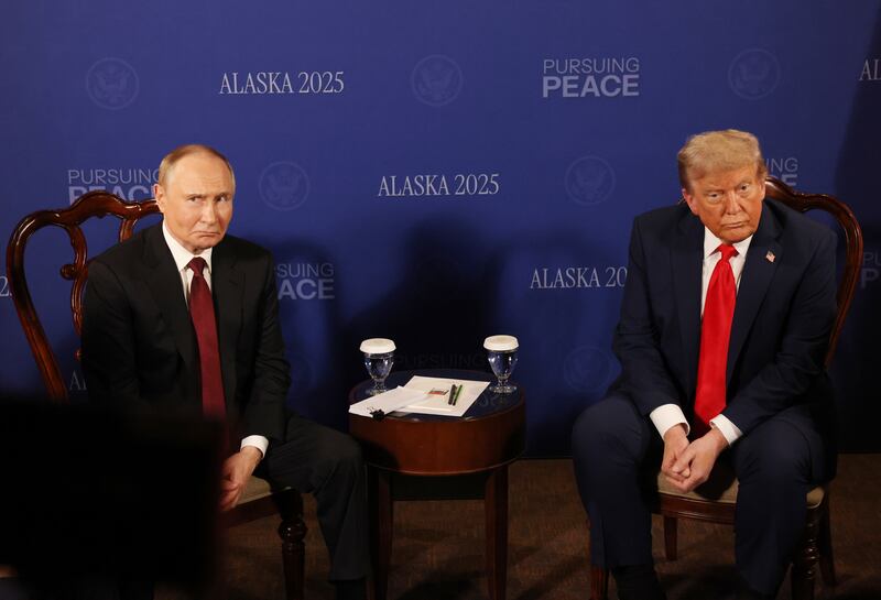 Russian President Vladimir Putin (L)looks on as U.S. President Donald Trump (R) reacts during their meeting on war in Ukraine.