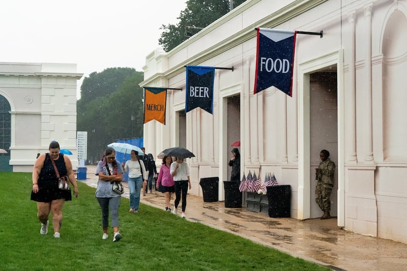 Visitors attend The Great American State Fair in the rain on the National Mall in Washington, D.C., U.S., June 28, 2026.