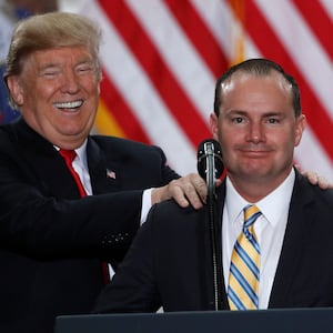 U.S. President Donald Trump jokes with Senator Mike Lee.