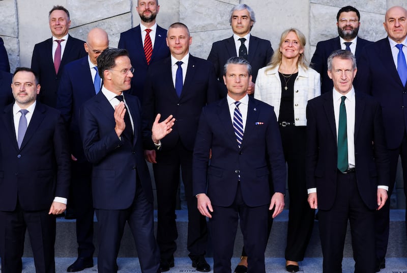 NATO Secretary General Mark Rutte gestures next to U.S. Defense Secretary Pete Hegseth and Britain’s Defence Secretary Dan Jarvis, as they pose for a family photo during a meeting of NATO Defence Ministers at the alliance's headquarters in Brussels, Belgium, June 18, 2026. REUTERS/Yves Herman