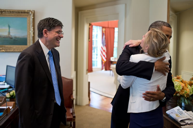 President Barack Obama is congratulated by Chief of Staff Jack Lew and Kathryn Ruemmler, who he is hugging, after learning of the Supreme Court's ruling on the Patient Protection and Affordable Care Act in 2012.