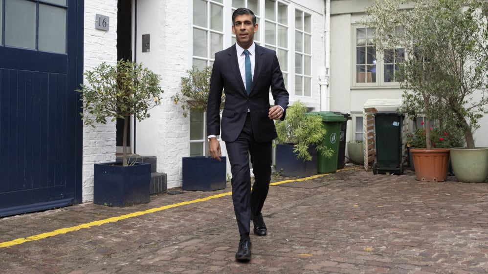 RIshi Sunak on brick patio outside his home in London