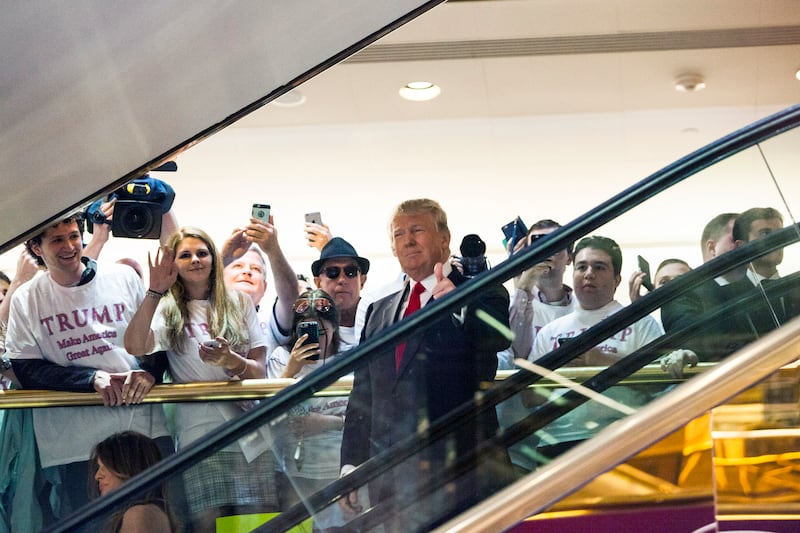 Donald Trump rides down an escalator at Trump Tower to announce his candidacy for president on June 16, 2015.