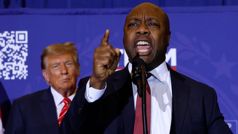 Sen. Tim Scott speaks as President Donald Trump looks on during a campaign rally at the Grappone Convention Center on January 19, 2024 in Concord, New Hampshire