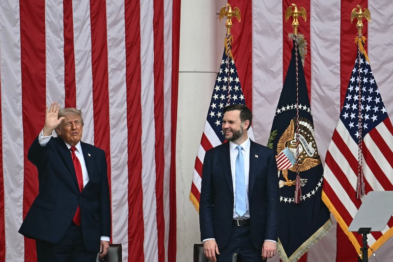 US President Donald Trump waves alongside Vice President JD Vance during the National Memorial Day Observance at the Memorial Amphitheatre in Arlington National Cemetery in Arlington, Virginia on May 25, 2026. (Photo by Kent NISHIMURA / AFP via Getty Images)