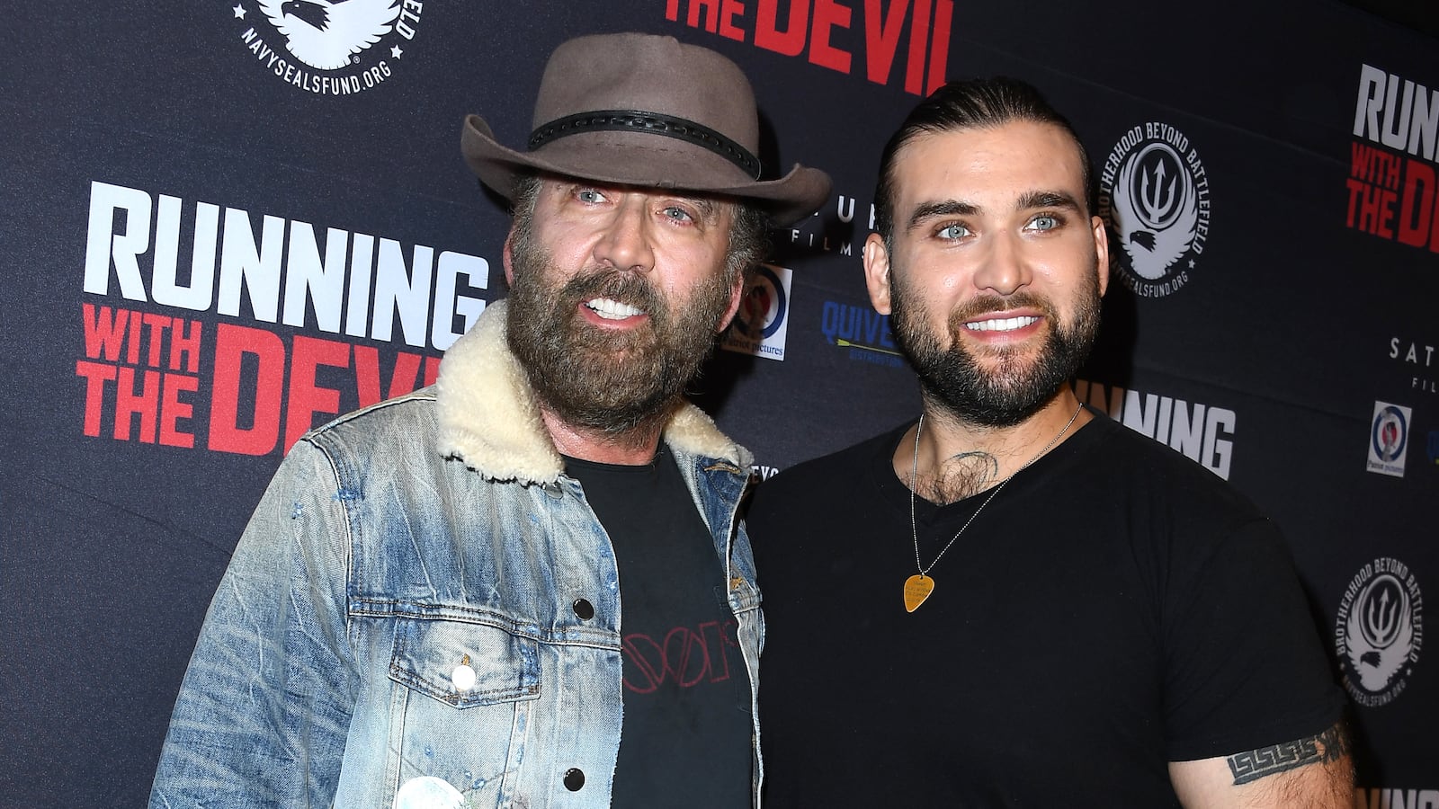 Nicolas Cage and Weston Cage Coppola at a movie premiere.