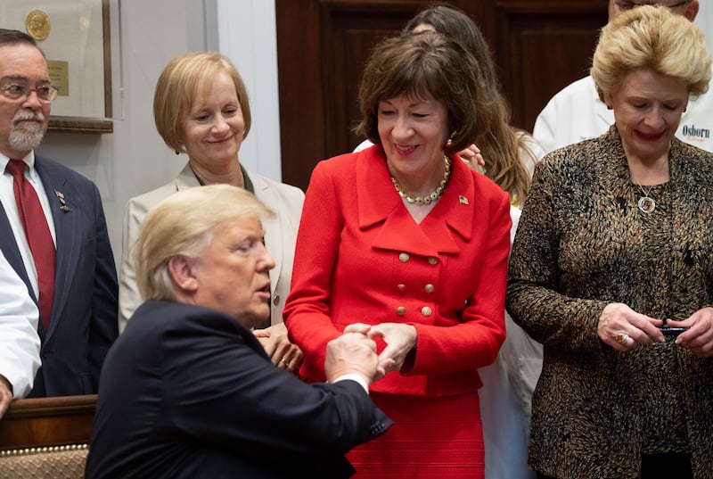 US President Donald Trump presents US Senator Susan Collins, Republican of Maine, with a pen after signing bills intended to lower prescription drug prices during a ceremony in the Roosevelt Room of the White House in Washington, DC, October 10, 2018. (Photo by SAUL LOEB / AFP)        (Photo credit should read SAUL LOEB/AFP via Getty Images)