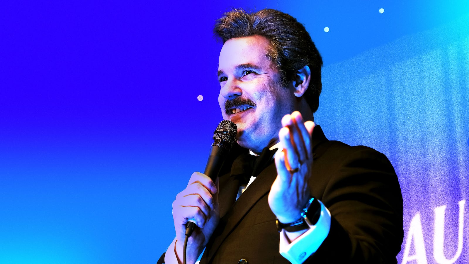 Photo illustration of Paul F Tompkins on a blue and purple background