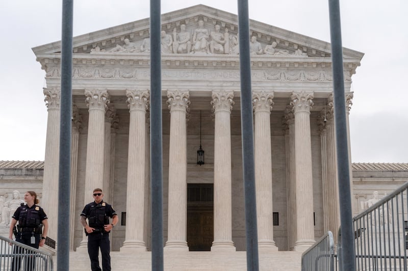 Police officers stand near barriers outside the Supreme Court.