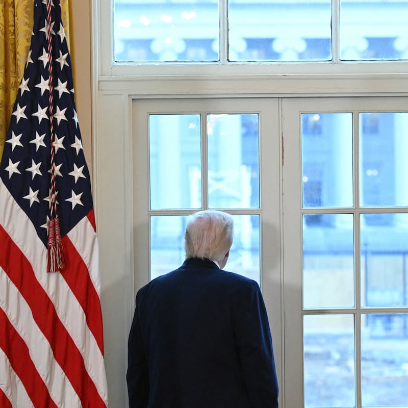 US President Donald Trump looks through a window to observe construction work on his new ballroom prior to a meeting with US oil company executives in the East Room of the White House in Washington, DC, on January 9, 2026. President Trump is aiming to convince oil executives to support his plans in Venezuela, a country whose energy resources he says he expects to control for years to come. US forces seized Venezuelan president Nicolas Maduro in a sweeping military operation on January 3, with Trump making no secret that control of Venezuela's oil was at the heart of his actions. (Photo by SAUL LOEB / AFP via Getty Images)