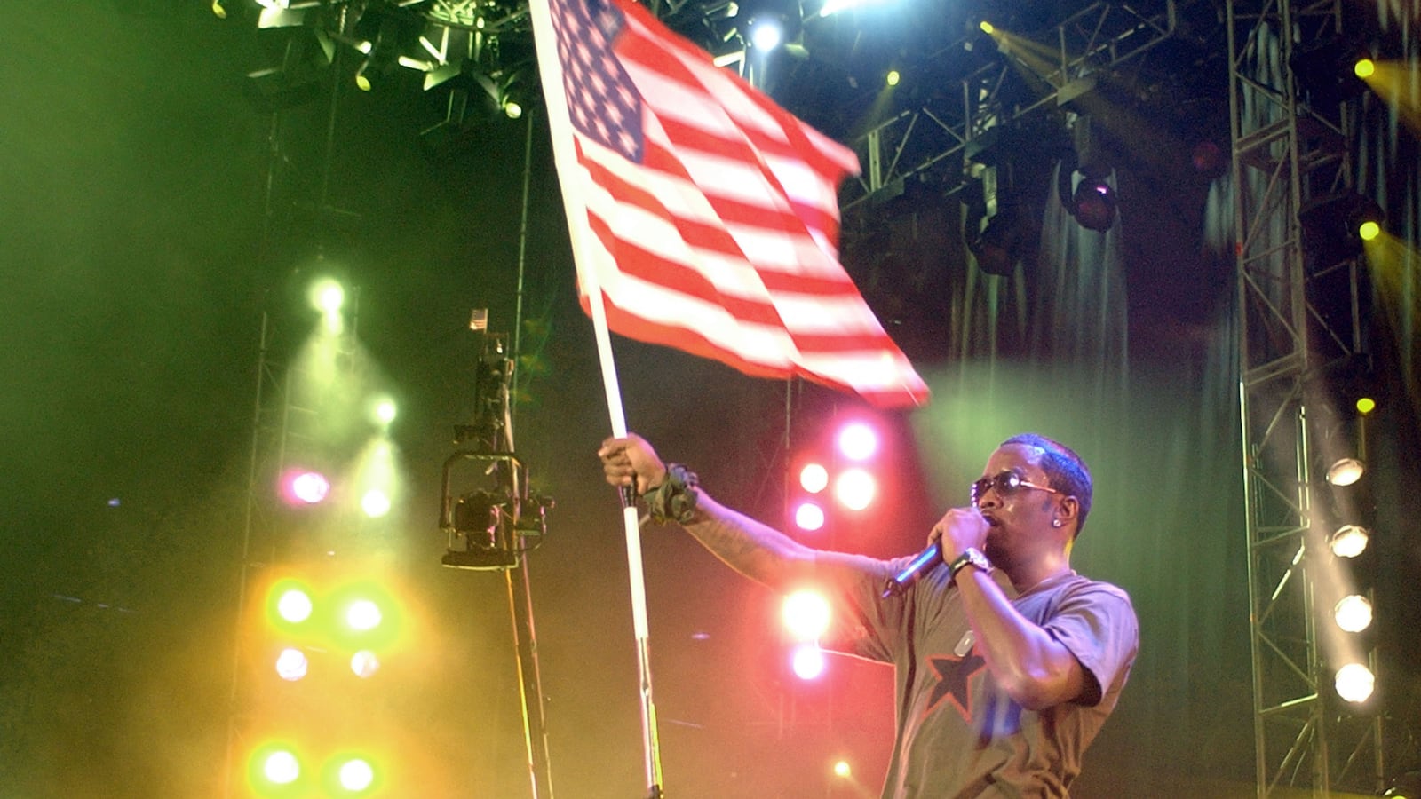 Sean "P. Diddy" Combs performs while waving an American flag.