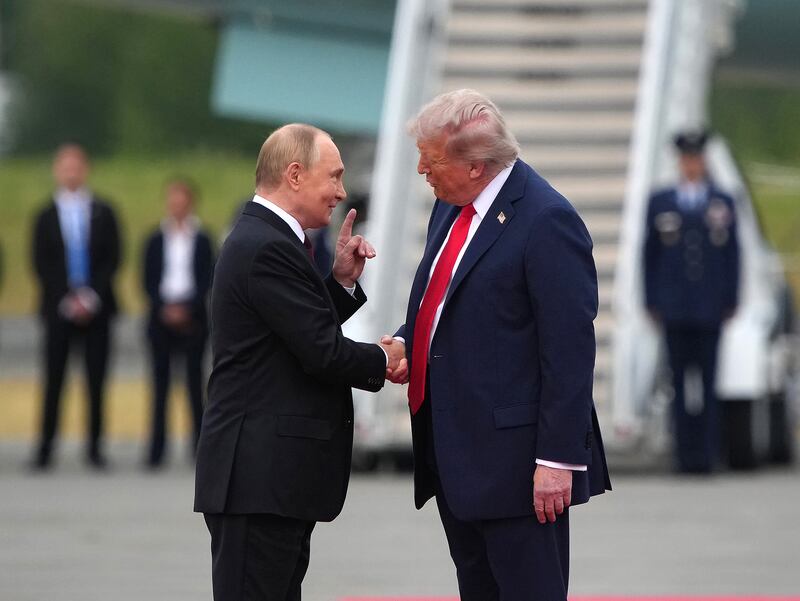 President Donald Trump greets Russian President Vladimir Putin as he arrives at Joint Base Elmendorf-Richardson on August 15, 2025 in Anchorage, Alaska.