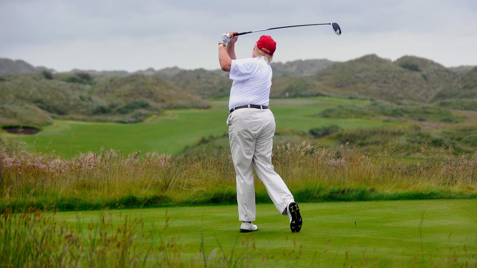 Donald Trump plays a stroke as he officially opens his new multi-million pound Trump International Golf Links course in Aberdeenshire, Scotland, on July 10, 2012.