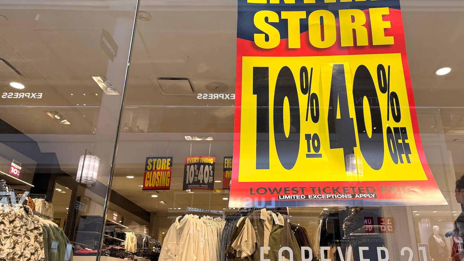 SAN FRANCISCO, CALIFORNIA - FEBRUARY 20: A sign advertising a storewide sale is displayed in a window at a Forever 21 store that is preparing to close on February 20, 2025 in San Francisco, California.
