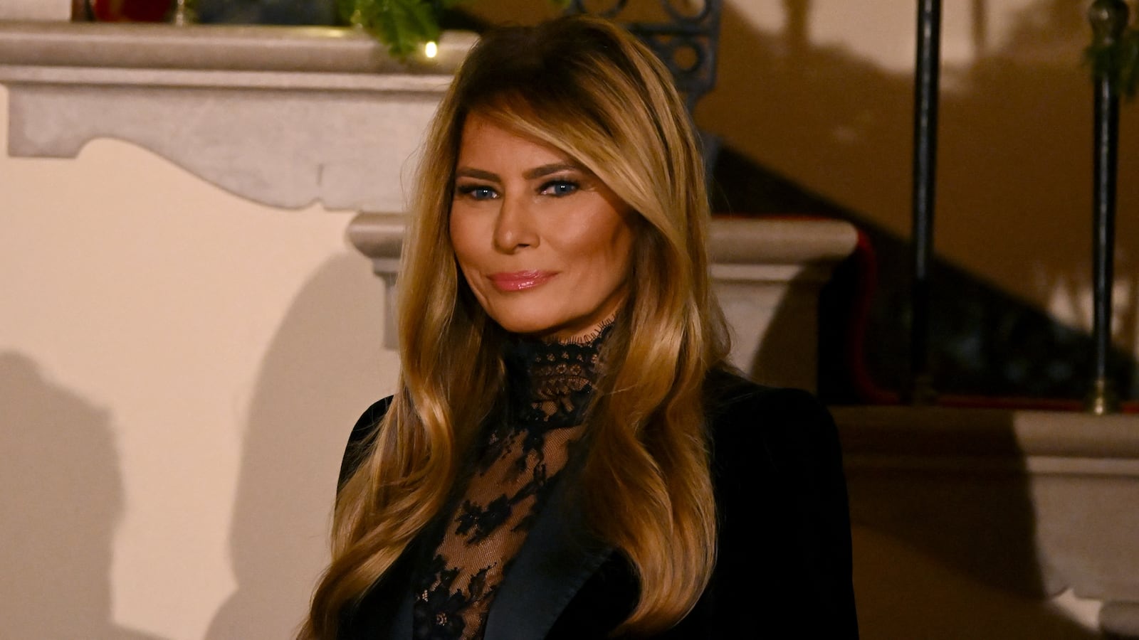 US First Lady Melania Trump looks on as President Donald Trump delivers remarks during the Congressional Ball in the Grand Foyer of the White House in Washington, DC, on December 11, 2025.