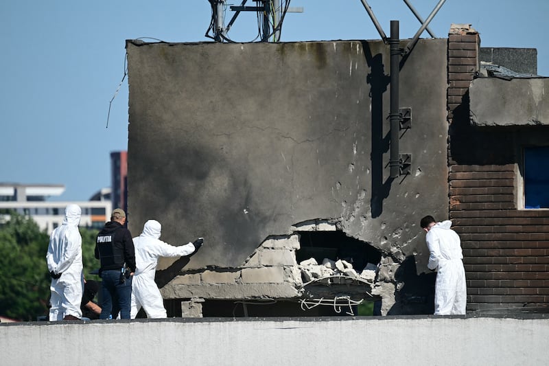 TOPSHOT - Police and forensic investigators examine the location of impact after a Russian drone struck an apartment building in Galati, eastern Romania. A Russian drone wounded two people as it struck an apartment building in NATO-member Romania, its defence ministry said on May 29, 2026, the latest spillover from the four-year war into neighbouring states. (Photo by Daniel MIHAILESCU / AFP via Getty Images)