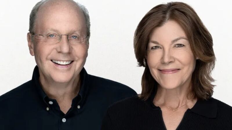 Jeff Yass in dark button down and his wife Janine in dark shirt pictured from the beck up