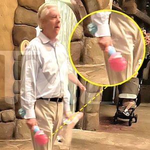 Sen. Lindsey Graham walking with a bubble wand at Disney World.