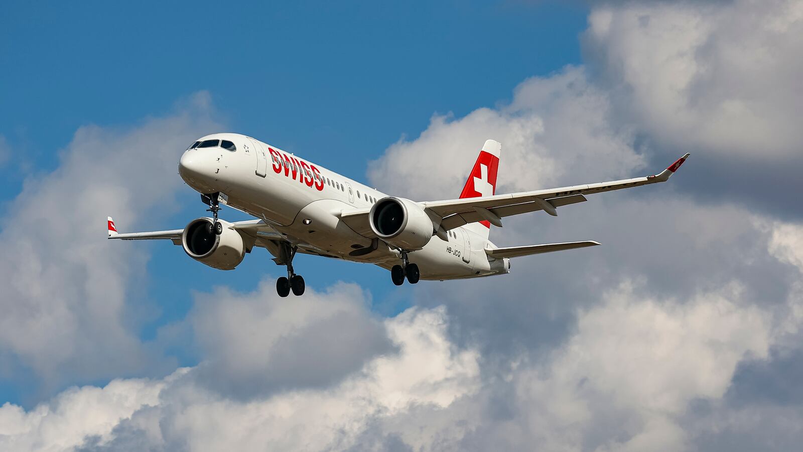 Swiss Airbus A220-300 aircraft or former Bombardier CS300 BD-500 model, as seen on final approach flying for landing at the runway of London Heathrow International Airport LHR.