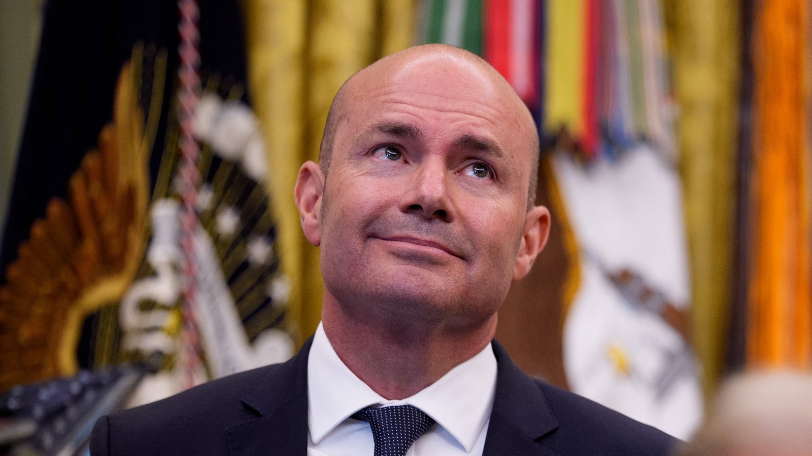 Sen. Mike Lee (R-UT) (L), and Utah Gov. Spencer Cox (R) stand behind U.S. President Donald Trump (C) as he speaks to members of the media during an executive order signing in the Oval Office of the White House on July 13, 2026 in Washington, DC. Trump signed two executive orders related to the transfer of federal land to the State of Utah.
