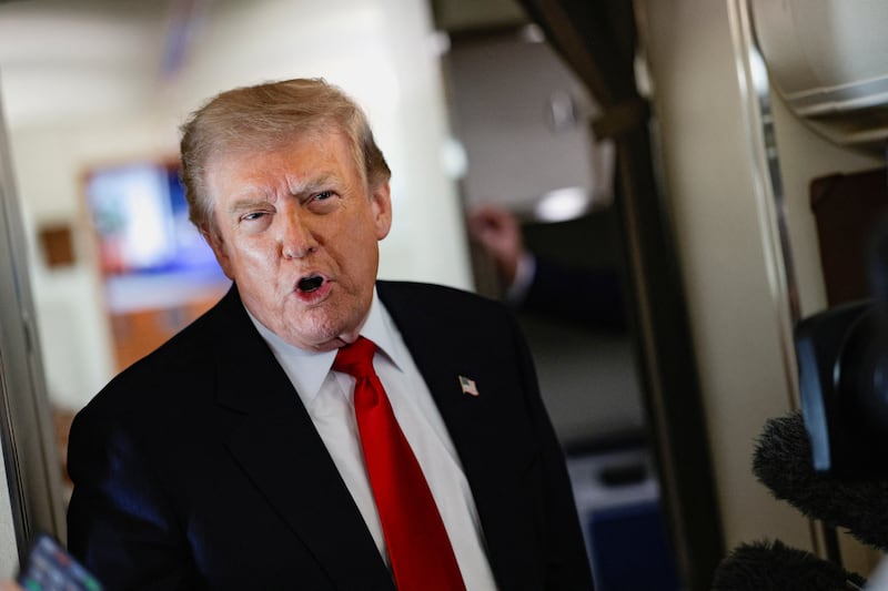U.S. President Donald Trump speaks to reporters aboard Air Force One en route to Michigan, U.S., July 27, 2026. REUTERS/Evan Vucci