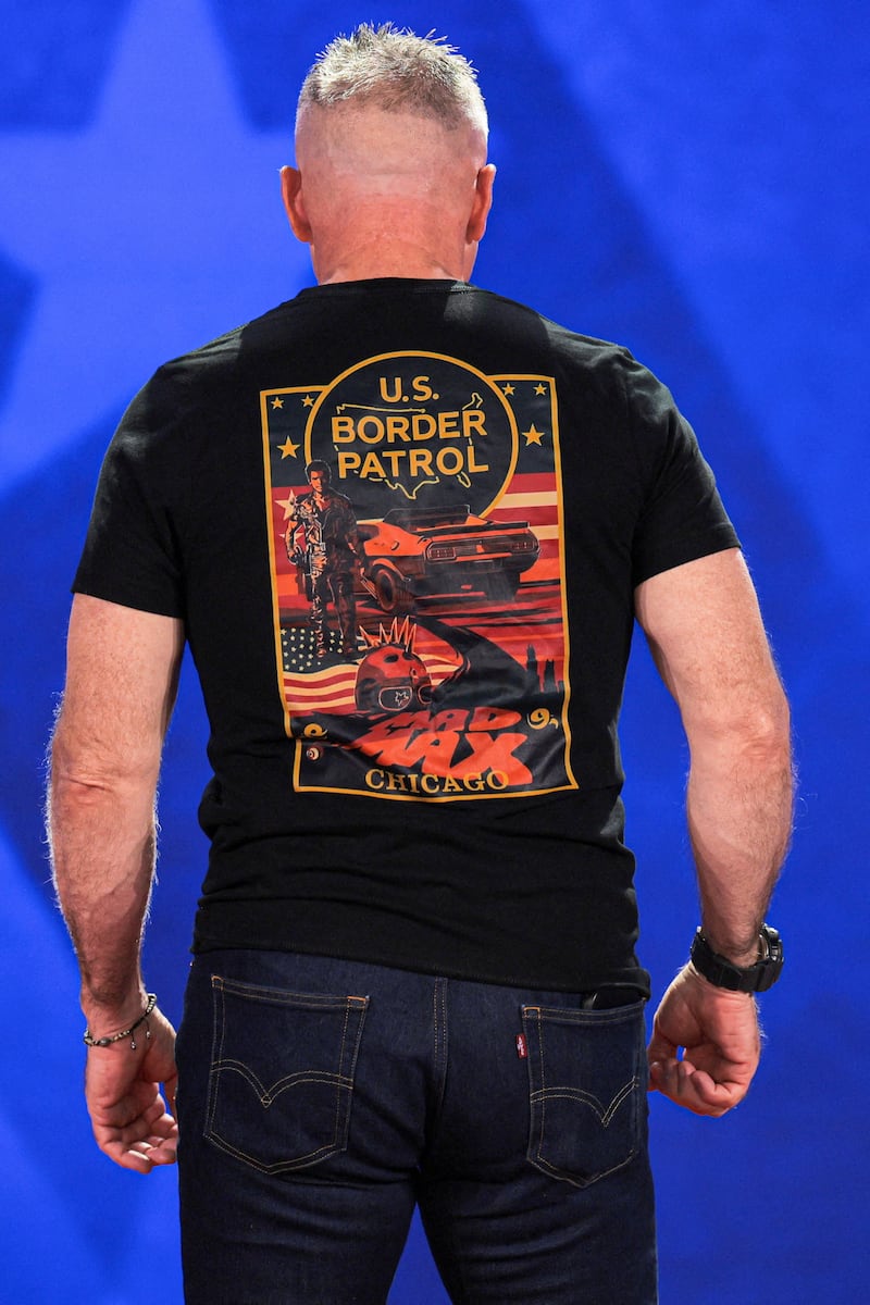 Former U.S. Border Patrol Chief Gregory Bovino wears a MAD MAX-inspired T-shirt as he attends the 2026 Conservative Political Action Conference (CPAC) in Grapevine, Texas, on March 26, 2026.
