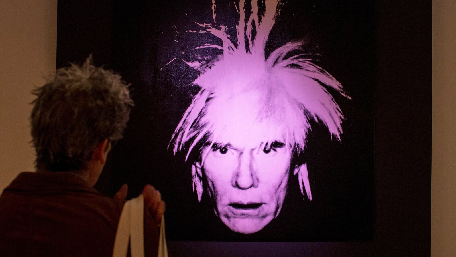 A man examines “Self-Portrait” by Andy Warhol during a media preview at Christie’s auction house in New York, Oct. 31, 2014.