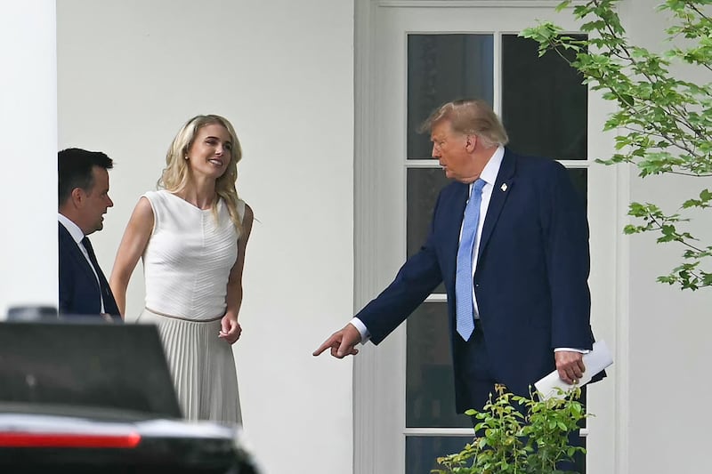 US President Donald Trump (R) speaks with aide Natalie Harp (2L) as they return to the White House following an event to unveil the new America.gov website, in Washington, DC, on September 29, 2026. (Photo by Kent NISHIMURA / AFP via Getty Images)
