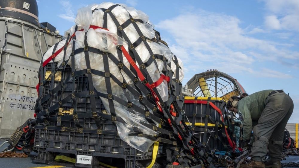 U.S. Navy personnel inspecting the remnants of a Chinese spy balloon.