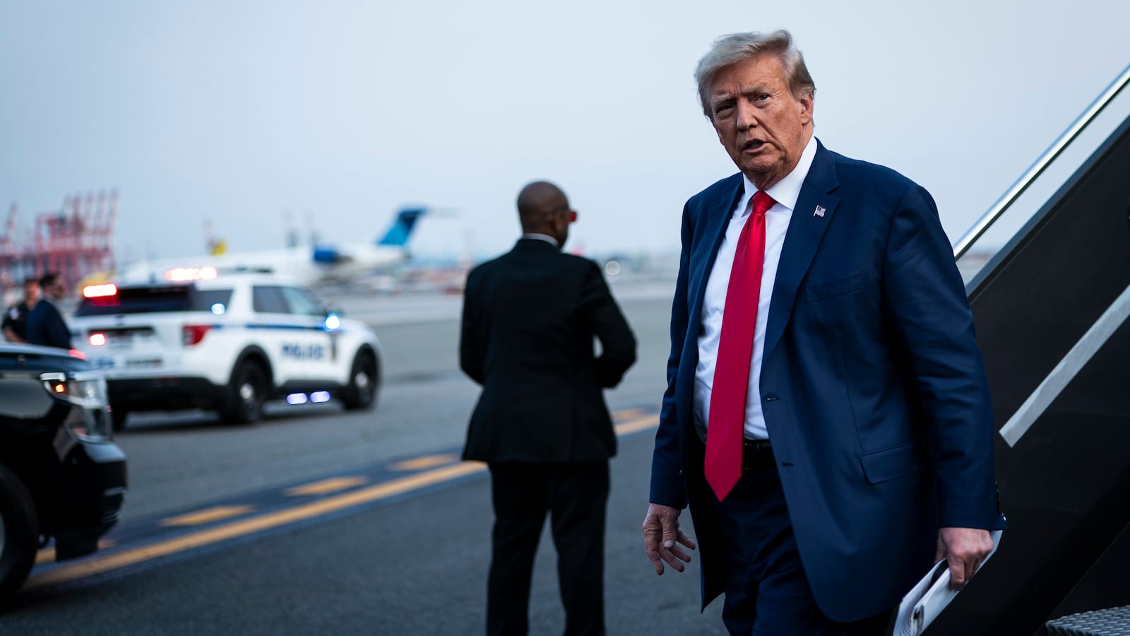 Former President Donald Trump disembarks his airplane
