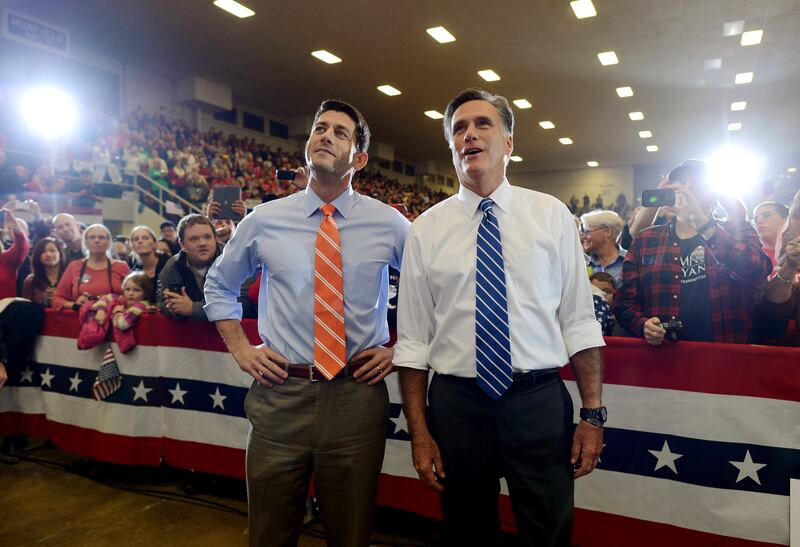 US Republican Presidential candidate Mitt Romney and his running mate Paul Ryan sing along during a musical performance at a rally at the Veterans Memorial Coliseum in Marion, Ohio on October 28, 2012. AFP PHOTO/Emmanuel DUNAND        (Photo credit should read EMMANUEL DUNAND/AFP via Getty Images)