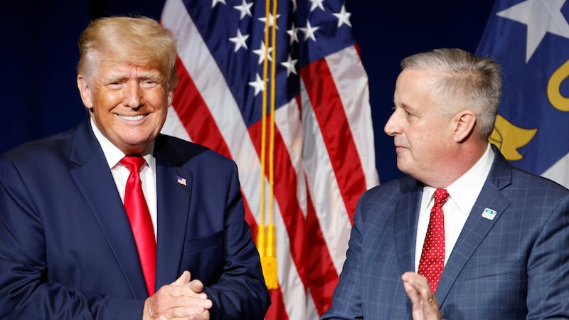 Then-North Carolina Republican Party chair Michael Whatley introduces Donald Trump at a 2021 state convention dinner. Trump would later convince him to run for the Senate.