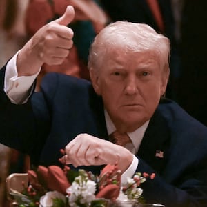 US President Donald Trump gives a thumbs up as he attends a Christmas dinner at his Mar-a-Lago resort in Palm Beach, Florida, on December 24, 2025. (Photo by ANDREW CABALLERO-REYNOLDS / AFP)