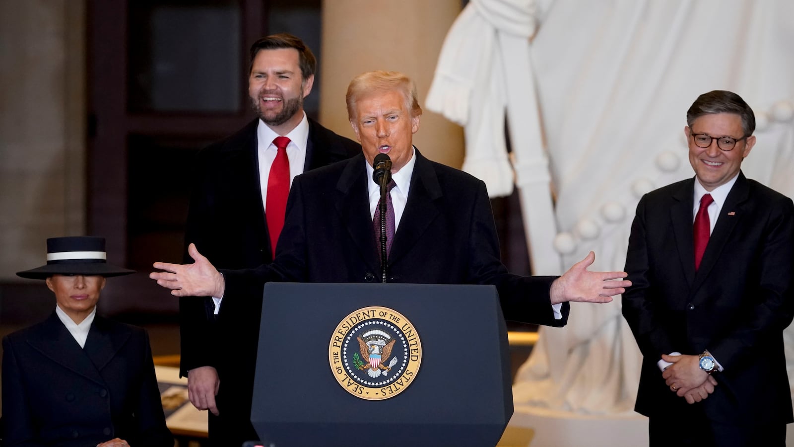 President Donald Trump speaks in Emancipation Hall after being sworn in at his inauguration as US First Lady Melania Trump, Vice President JD Vance, and US House Speaker Mike Johnson, a Republican from Louisiana, look on in the U.S. Capitol Rotunda.