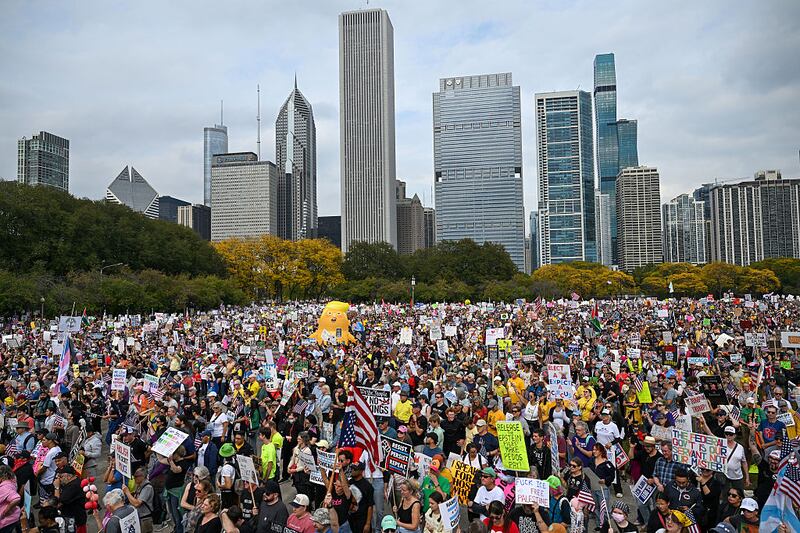 Demonstrators protest during the "No Kings" march at Grant Park on October 18, 2025 in Chicago, Illinois. Thousands of people attended the protest to speak out against President Donald Trump and his administration.