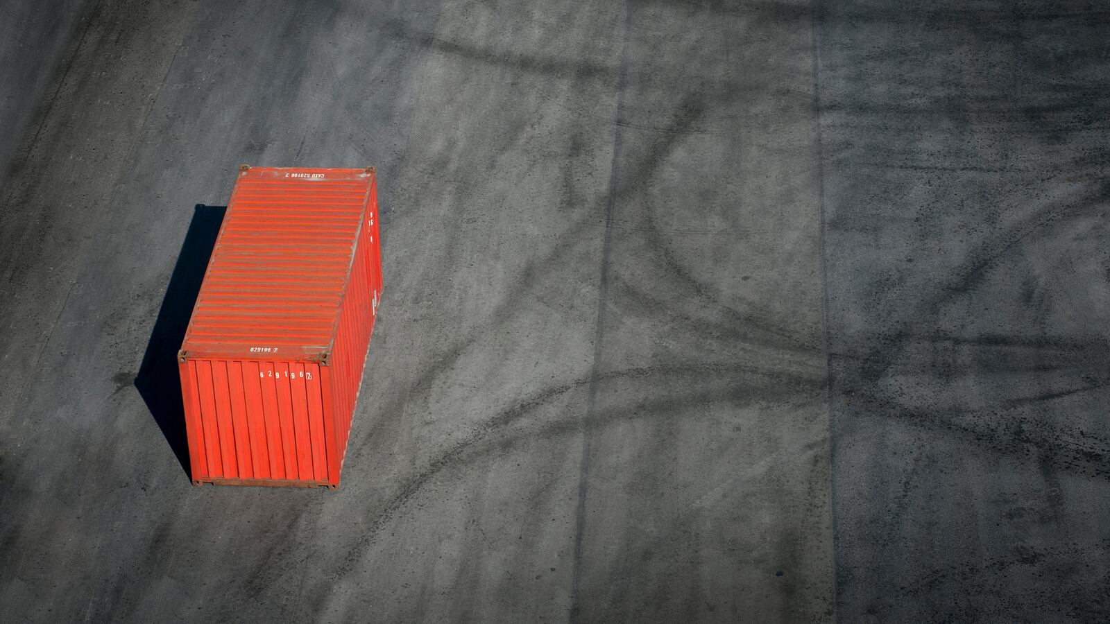 Red container on a dock.